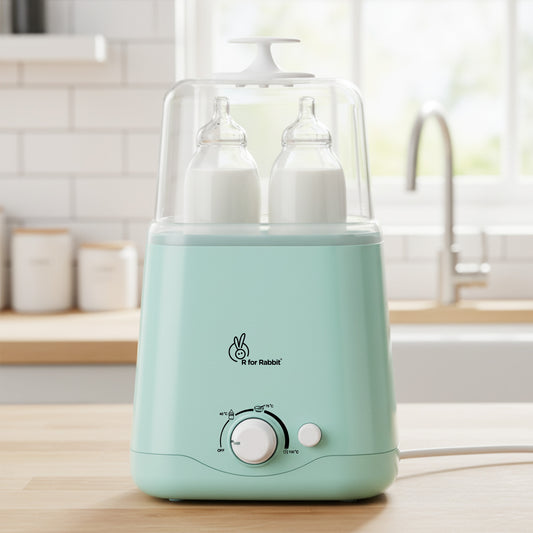 Mint green baby bottle warmer with two bottles on a kitchen counter