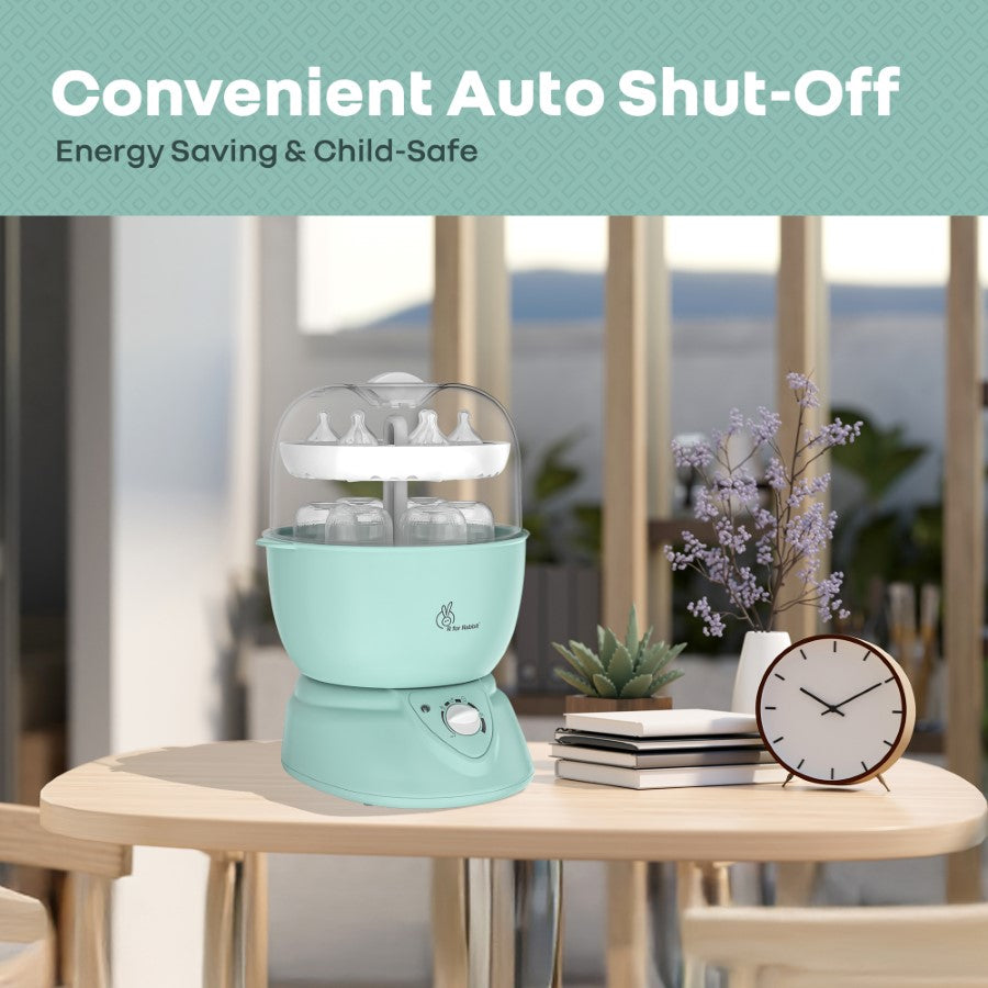 Mint green baby bottle dryer on a table with decorative items, featuring text about auto shut-off and energy saving.
