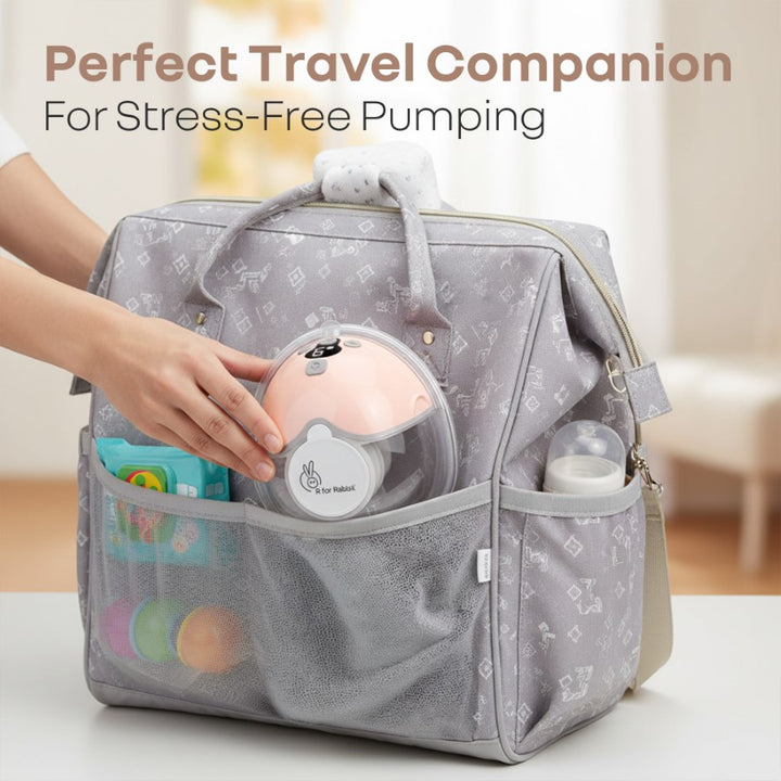Gray diaper bag with baby items and text 'Perfect Travel Companion For Stress-Free Pumping'.